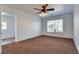 Spacious bedroom featuring a ceiling fan, plush carpet, and a bright window view at 3924 Diamond Ridge St, Las Vegas, NV 89129