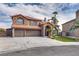 Charming two-story home featuring a stone facade, three-car garage, arched entryway, and desert landscaping at 3924 Diamond Ridge St, Las Vegas, NV 89129