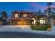 Charming two-story home with a three-car garage, well-maintained lawn, and beautiful stone accents at 3924 Diamond Ridge St, Las Vegas, NV 89129