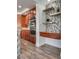 A stylish kitchen with stainless steel appliances, wooden cabinets, wine wracks, and modern backsplash creates a sophisticated cooking space at 3924 Diamond Ridge St, Las Vegas, NV 89129