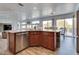 A well-lit kitchen features modern stainless steel appliances, wood cabinets, and a breakfast bar with views of the dining area at 3924 Diamond Ridge St, Las Vegas, NV 89129