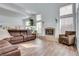 Bright living room with a fireplace, high ceilings, and wood-look flooring at 3924 Diamond Ridge St, Las Vegas, NV 89129
