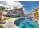 Inviting backyard pool with rock features, artificial grass, palm trees, and backyard patio at 3924 Diamond Ridge St, Las Vegas, NV 89129