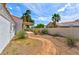 Beautiful backyard with desert landscaping, covered patio, and winding path, perfect for outdoor relaxation and entertaining at 4117 Sinew Ct, Las Vegas, NV 89129