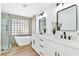 Bright bathroom featuring double sinks, modern fixtures, and a separate tub and shower at 4117 Sinew Ct, Las Vegas, NV 89129