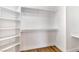 Walk-in closet with built-in shelving and wood floors at 4117 Sinew Ct, Las Vegas, NV 89129