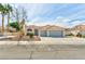 Inviting front exterior showcasing a well-maintained lawn, desert landscaping, and a two-car garage at 4117 Sinew Ct, Las Vegas, NV 89129