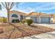 Attractive front exterior with a well-manicured landscape, desert landscaping, and a two-car garage at 4117 Sinew Ct, Las Vegas, NV 89129