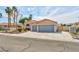 Beautiful front exterior featuring a well-maintained lawn, desert landscaping, and a two-car garage at 4117 Sinew Ct, Las Vegas, NV 89129