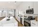 Modern white kitchen featuring a large island, stainless steel appliances, and open layout at 4117 Sinew Ct, Las Vegas, NV 89129