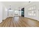 Bright living room featuring wood floors, plantation shutters, and a black marble fireplace accent wall at 4117 Sinew Ct, Las Vegas, NV 89129