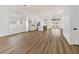 Expansive living area with wood floors, white walls, and an open-concept kitchen at 4117 Sinew Ct, Las Vegas, NV 89129