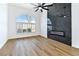 Stylish living room with wood floors, modern fireplace, and large window at 4117 Sinew Ct, Las Vegas, NV 89129