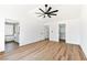 Spacious main bedroom with wood floors, ceiling fan and access to the ensuite bathroom and walk-in closet at 4117 Sinew Ct, Las Vegas, NV 89129