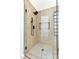 Contemporary shower with black hardware, glass enclosure and neutral stone-look tiling at 4117 Sinew Ct, Las Vegas, NV 89129
