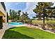 Expansive backyard with a sparkling pool, built-in barbecue area, and stunning views of the lush golf course at 42 Gulf Stream Ct, Las Vegas, NV 89113
