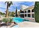 Inviting backyard with a sparkling pool, spa, and lush landscaping at 42 Gulf Stream Ct, Las Vegas, NV 89113
