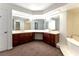 Bright bathroom featuring double vanities, large mirrors, and soaking tub at 42 Gulf Stream Ct, Las Vegas, NV 89113