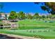 Expansive golf course view features a pond with geese and rolling greens, set against a backdrop of mountains at 42 Gulf Stream Ct, Las Vegas, NV 89113