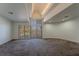 Open living room with beamed ceilings and natural light, offering space and relaxation at 42 Gulf Stream Ct, Las Vegas, NV 89113