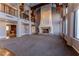 Expansive living area with fireplace, wooden accents, built-ins, and large windows for natural light and scenic views at 42 Gulf Stream Ct, Las Vegas, NV 89113