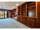 Spacious living area with a built-in bookcase and shelving surrounding a cozy fireplace at 42 Gulf Stream Ct, Las Vegas, NV 89113