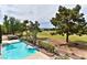 Backyard view featuring a sparkling pool, a lush lawn, and scenic golf course views at 42 Gulf Stream Ct, Las Vegas, NV 89113