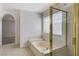The bright bathroom features a tub and a glass enclosed shower at 5 Tarryall Ter, Henderson, NV 89074