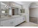 Bathroom with double sinks featuring generous mirror and view into the bedroom at 5 Tarryall Ter, Henderson, NV 89074