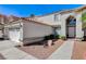 Lovely stucco home with terracotta roof, trimmed shrubs and desert landscaping at 5 Tarryall Ter, Henderson, NV 89074