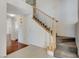 Bright foyer showcasing a staircase with wood railing, and tile and wood flooring at 5 Tarryall Ter, Henderson, NV 89074