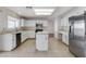 Well-equipped kitchen with stainless steel appliances, an island and white cabinets, creating a functional space at 5 Tarryall Ter, Henderson, NV 89074
