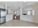 Open-concept kitchen with stainless steel appliances and an adjacent living room with a fireplace creating a cozy ambiance at 5 Tarryall Ter, Henderson, NV 89074