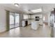 Spacious kitchen with white cabinetry, stainless appliances, an island, and sliding door access to the patio at 5 Tarryall Ter, Henderson, NV 89074