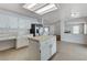 Spacious kitchen featuring stainless steel appliances, an island, and an adjacent living room with a fireplace at 5 Tarryall Ter, Henderson, NV 89074