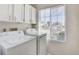Laundry room features full size washer and dryer with a large window at 5 Tarryall Ter, Henderson, NV 89074