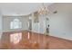 Open concept living room featuring hardwood floors, multiple windows and access to the kitchen area at 5 Tarryall Ter, Henderson, NV 89074