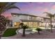 Backyard features a pool, jacuzzi, manicured landscaping, and a covered patio, ideal for relaxation at 5225 Villa Dante Ave, Las Vegas, NV 89141