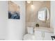 Stylish powder room with floating vanity, vessel sink, pendant lighting, and a unique oval mirror at 5225 Villa Dante Ave, Las Vegas, NV 89141