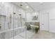 Luxurious bathroom showcases a seamless glass shower, rainfall showerheads, and a freestanding soaking tub at 5225 Villa Dante Ave, Las Vegas, NV 89141