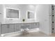 Modern bathroom with double vanity, floating cabinets, and designer mirrors and fixtures at 5225 Villa Dante Ave, Las Vegas, NV 89141