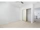 Spacious bedroom boasts plush carpet, a ceiling fan, and a mirrored closet at 5225 Villa Dante Ave, Las Vegas, NV 89141