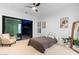 Bright bedroom features a ceiling fan, neutral carpet, and large glass doors to let the sunshine in at 5225 Villa Dante Ave, Las Vegas, NV 89141