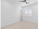 Bright bedroom with ceiling fan, neutral carpet, and window with wooden shutters at 5225 Villa Dante Ave, Las Vegas, NV 89141