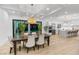 Dining room with views of the outdoor pool, a wooden table, and access to the modern kitchen at 5225 Villa Dante Ave, Las Vegas, NV 89141