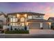 Beautiful two-story home with a manicured lawn, three-car garage, and classic curb appeal, illuminated at sunset at 5225 Villa Dante Ave, Las Vegas, NV 89141
