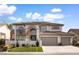 Beautiful two-story home with a three-car garage and lush green lawn at 5225 Villa Dante Ave, Las Vegas, NV 89141