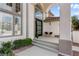 Beautiful home entrance boasting large windows, an arched transom, and a comfortable seating area at 5225 Villa Dante Ave, Las Vegas, NV 89141