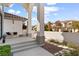 Charming front entrance with a quaint seating area, decorative pumpkins, and attractive landscaping at 5225 Villa Dante Ave, Las Vegas, NV 89141
