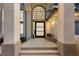 Welcoming front entrance featuring an arched window and a cozy seating area on the porch at 5225 Villa Dante Ave, Las Vegas, NV 89141